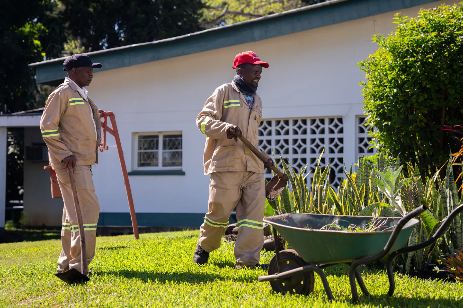 Groundskeepers tending the estate gardens