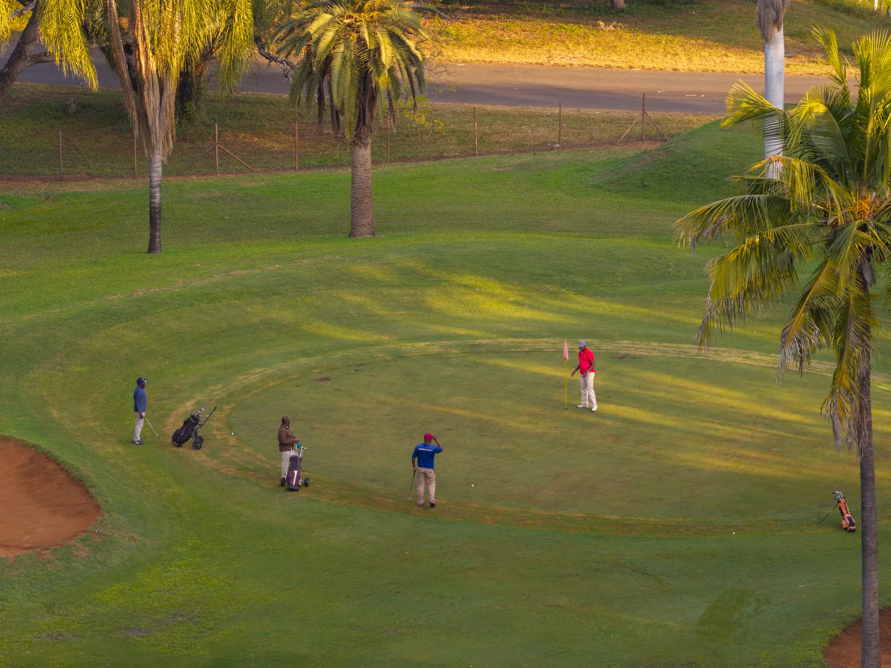 Golfers on the championship course at golden hour